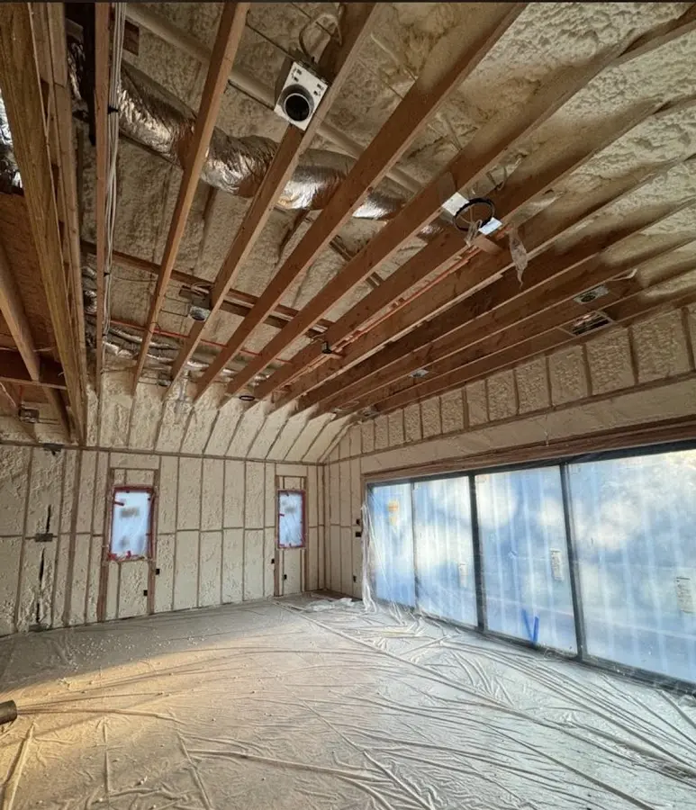 Interior walls and ceiling insulated with spray foam during new construction in Chackbay